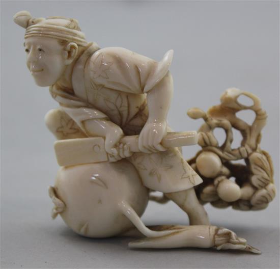 A Japanese ivory okimono of a farmer cutting a large turnip, signed Gyokushi, late 19th / early 20th century, 7cm, slight restorations